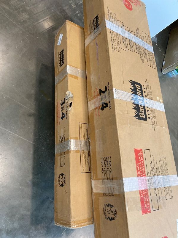 Photo 1 of ***PARTIAL SET*** Backyard Discovery Echo Heights Elevated Cedar Wooden Kids Playhouse with Wave Slide, Play Kitchen, Wrap-Around Deck, Flat-Step Ladder, Half Door, Windows, Bell, and Growth Chart for Outdoor Play