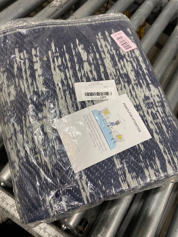 Photo 1 of MontVoo Outdoor Rug Waterproof 5x8 ft Outdoor Carpet Patio Rug Mat Reversible RV Camping Rug Plastic Straw Outside Rug for Balcony Porch Deck Picnic Beach Modern Navy