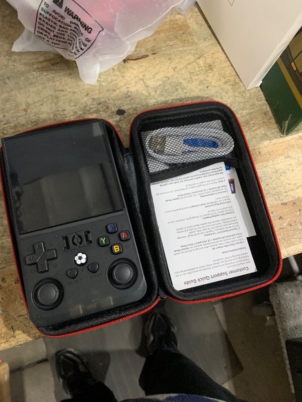 Photo 1 of ?R36MAX 4000mAh Portable Rechargeable Handheld Retro Game Console,Comfort Non-Slip Handheld Standing Retro Game Console with 64G TF Car,4.0-inch Screen,for Office,Black