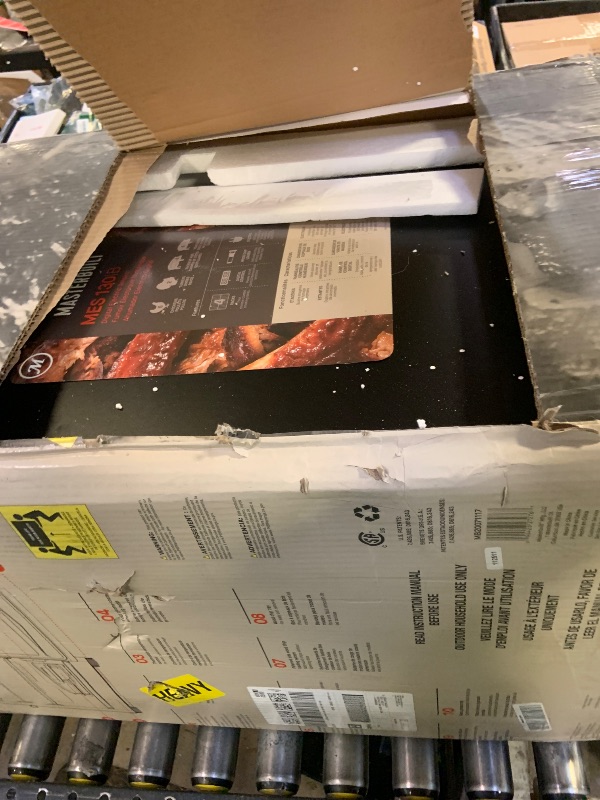 Photo 1 of Masterbuilt® 30-inch Digital Electric Vertical BBQ Smoker with Side Wood Chip Loader, Chrome Racks and 710 Cooking Square Inches in Black, Model MB20071117