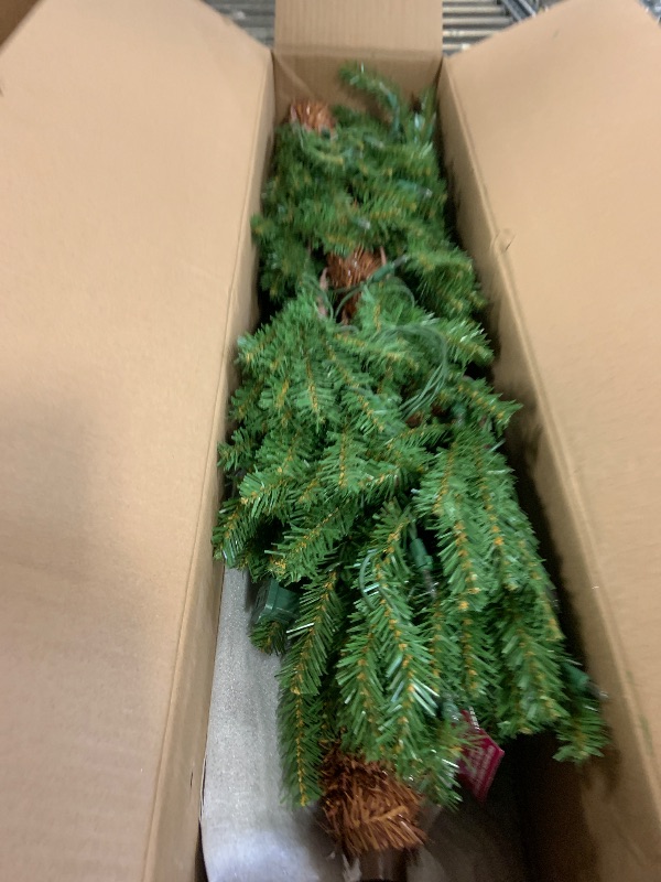 Photo 1 of National Tree Company 6 ft Pre-Lit Hickory Cedar Artificial Christmas Tree, 200 Clear Lights, 476 Tips, Metal Plate Base, Green