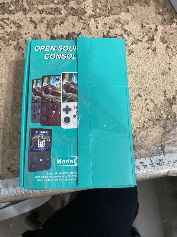 Photo 1 of ?R36MAX 4000mAh Portable Rechargeable Handheld Retro Game Console,Comfort Non-Slip Handheld Standing Retro Game Console with 64G TF Car,4.0-inch Screen,for Office,Black