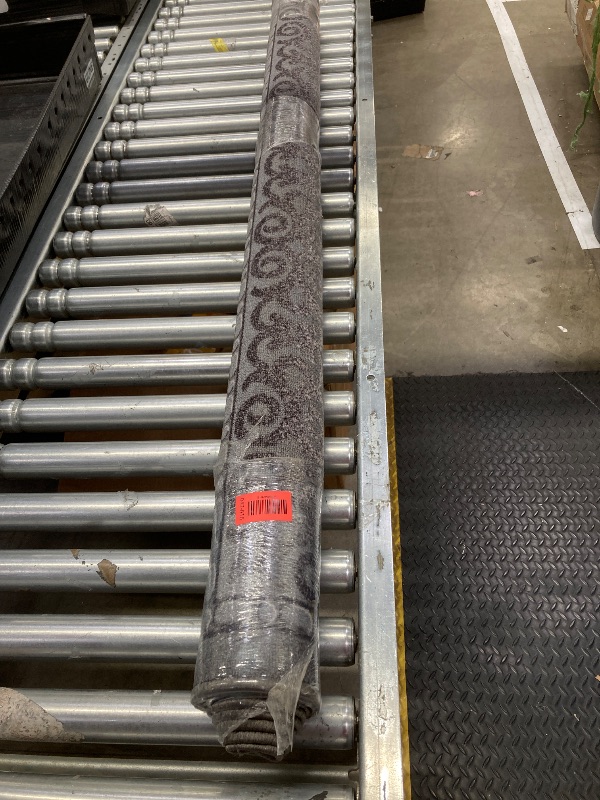 Photo 1 of 
dark grey rug with flowers on the boarder