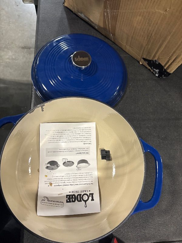 Photo 1 of *DAMAGED**
Lodge 6 Quart Enameled Cast Iron Dutch Oven with Lid – Dual Handles – Oven Safe up to 500° F or on Stovetop - Use to Marinate, Cook, Bake, Refrigerate and Serve – Indigo