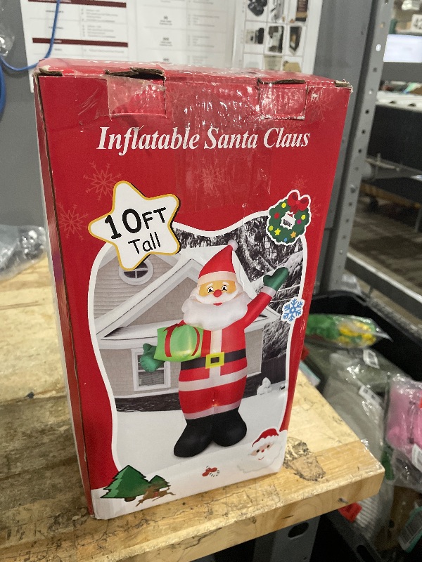 Photo 1 of 10 FT Christmas Inflatable Santa Claus Outdoor Decorations, Blow Up Santa Claus Holding Gift Box for Xmas Outside Decor, Giant Santa with Bright LED Lights for Yard Patio Garden Lawn Holiday Party