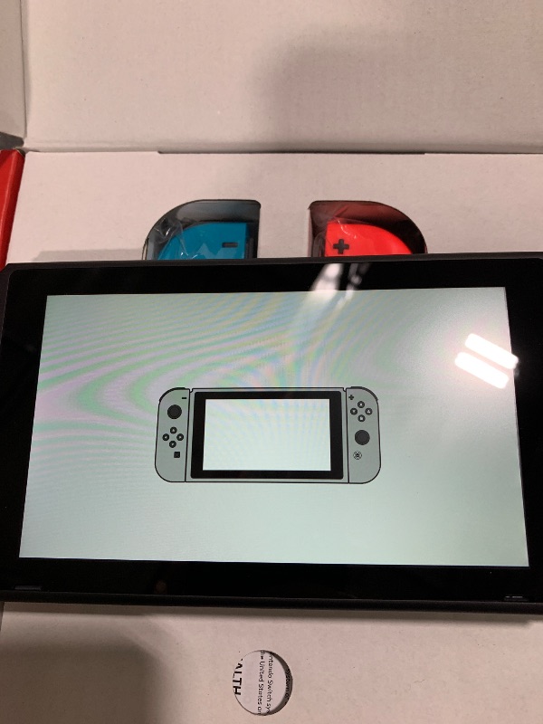 Photo 1 of ITEM NON FUNCTIONAL ---------------------------- PARTS ONLY ---------------------------------------------------------------------------Nintendo Switch™ with Neon Blue and Neon Red Joy?Con™