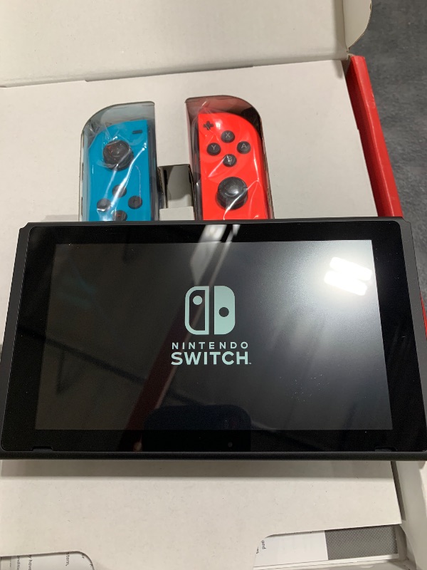 Photo 1 of ITEM NON FUNCTIONAL ---------------------------- PARTS ONLY ---------------------------------------------------------------------------Nintendo Switch™ with Neon Blue and Neon Red Joy?Con™
