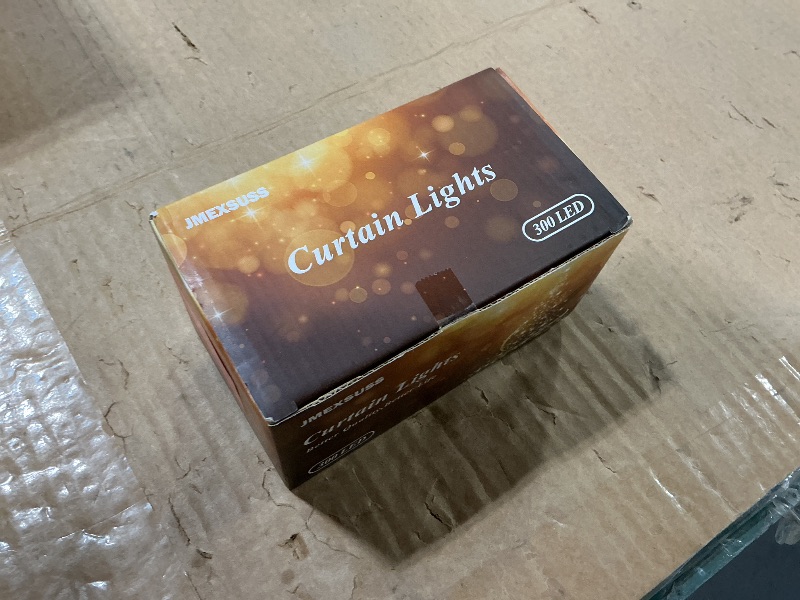 Photo 1 of JMEXSUSS 300 LED Remote Control Curtain Lights, Plug in Fairy Curtain Lights Outdoor, Window Wall Hanging String Lights for Bedroom Indoor Dorm Backdrop Wedding Party Patio Christmas Decor, Warm White