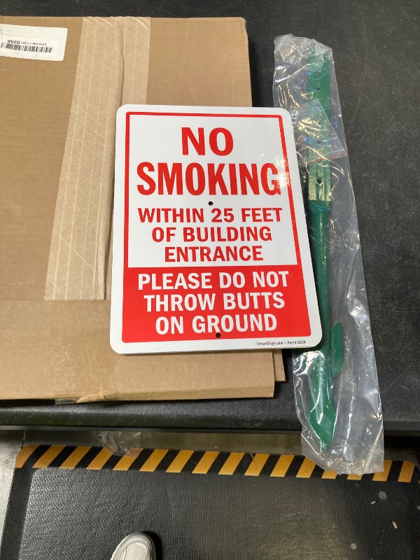 Photo 1 of SmartSign 10" x 7" 'No Smoking Within 25 Feet Of Building Entrance - Do Not Throw Butts On Ground' Yard Sign and 18 inch Stake Kit, 40 mil Laminated Aluminum, Red and White