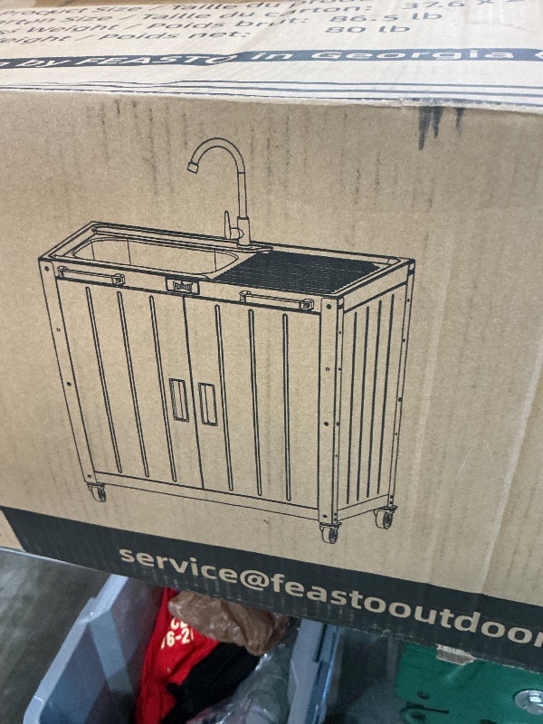Photo 1 of *MISSING PARTS - see clerk notes*
Feasto Outdoor Kitchen Island with Stainless Steel Sink and Storage Cabinet, 35-Inch BBQ Prep Station with Faucet & Lockable Wheels for Patio, Backyard, and Outdoor Cooking, Black & Silver