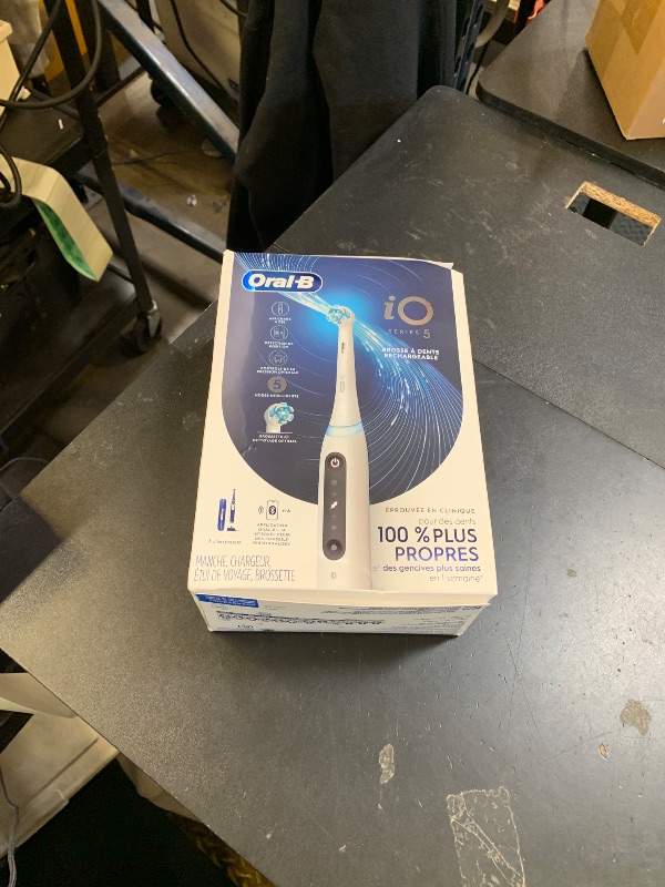 Photo 1 of Oral-B Rechargeable Electric Toothbrush, iO5 Customizable Clean, 5 Cleaning Modes, Visual Pressure Sensor to Protect Gums, Travel Case, White