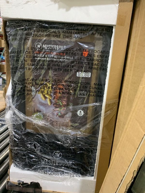 Photo 1 of Masterbuilt® 30-inch Digital Electric Vertical BBQ Smoker with Leg Kit, Side Wood Chip Loader and 710 Cooking Square Inches in Black, Model MB20070421094428276642
