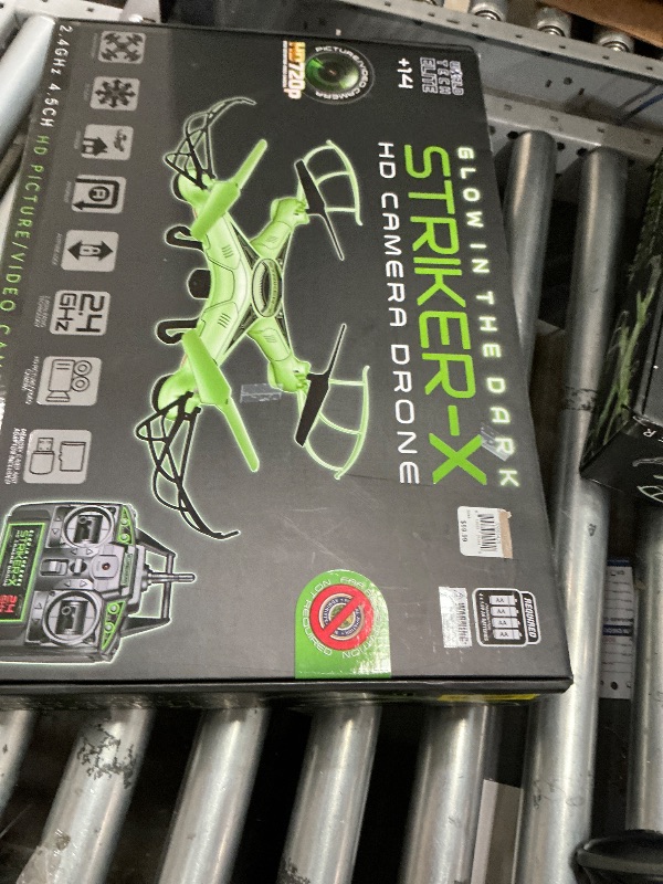 View 1 of **UPDATED PHOTOS**Striker-X Glow in the Dark HD Camera Drone – 2.4GHz 4.5CH RC Quadcopter with 720p Picture & Video Camera – 4GB Memory Card Included – Altitude Lock, Flip Stunt Mode, Hover Mode – Drone for Ages 14+