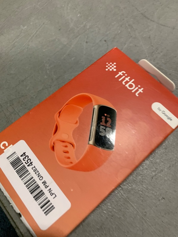 Photo 1 of Fitbit Charge 6 Fitness Tracker with Google apps, Heart Rate on Exercise Equipment, 6-Months Premium Membership Included, GPS, Health Tools and More, Gold/Coral, One Size (S & L Bands Included)