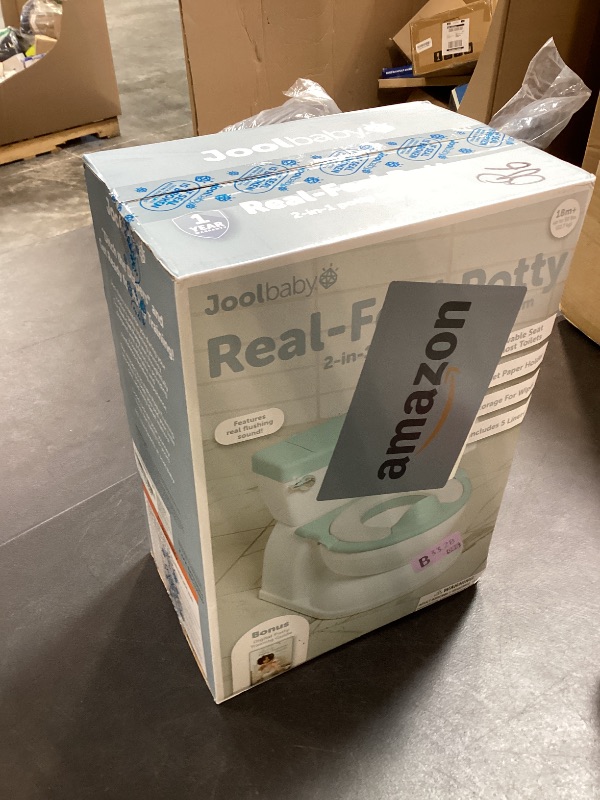 Photo 1 of Real Feel 2-in-1 Potty with Wipes Storage, Flushing Sounds & Disposable Liners - Realistic Toilet - Easy to Clean & Assemble - Jool Baby (Aqua)