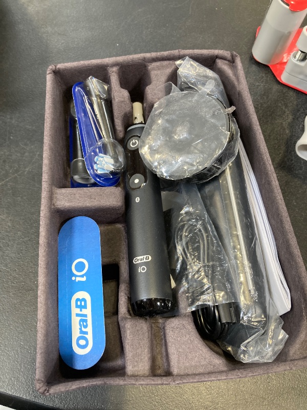 Photo 1 of Oral-B Rechargeable Electric Toothbrush, iO9 Limited Ultimate Clean, 7 Cleaning Modes, Interactive Display, iSense Charger, Charging Travel Case, Visible Pressure Sensor, 3 Brush Heads, Black