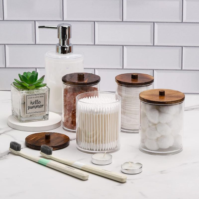 Photo 1 of Tbestmax 4 Pack Qtip Holder Dispenser Cotton Ball, Cotton Swab, Floss - 12oz, 10 oz Clear Plastic Apothecary Jars for Bathroom Organizer and Storage Containers (Brown Wood Lids)