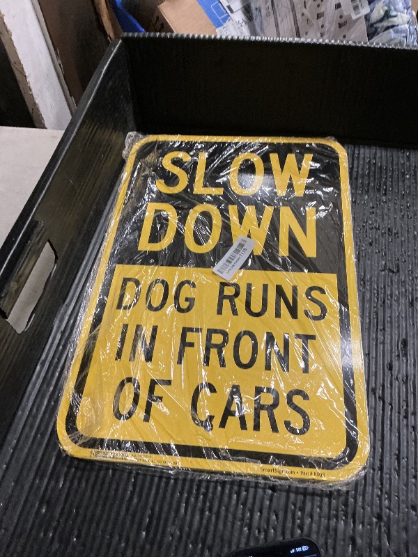 Photo 1 of SmartSign Slow Down Dog Runs In Front of Cars Sign - 2-Pack, 12" x 18", 80 mil Thick Aluminum Composite (ACM), Pre-Drilled Holes, Yellow and Black, Made in USA