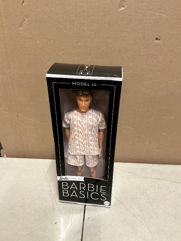 View 2 of Barbie Basics Model Collector Ken Fashion Doll 10 with Brunette Hair in Shirt & Shorts with Matching Print, Universal-fit Fashions & Posable Body
