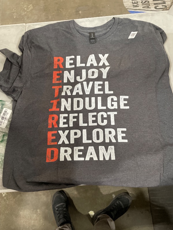Photo 1 of "RETIRED" acronym shirt is a custom-printed design often found on Gildan Softstyle blanks. While the exact combination of words shown—Relax, Enjoy, Travel, Indulge, Reflect, Explore, Dream—is commonly used in customized retirement gifts----X-Large