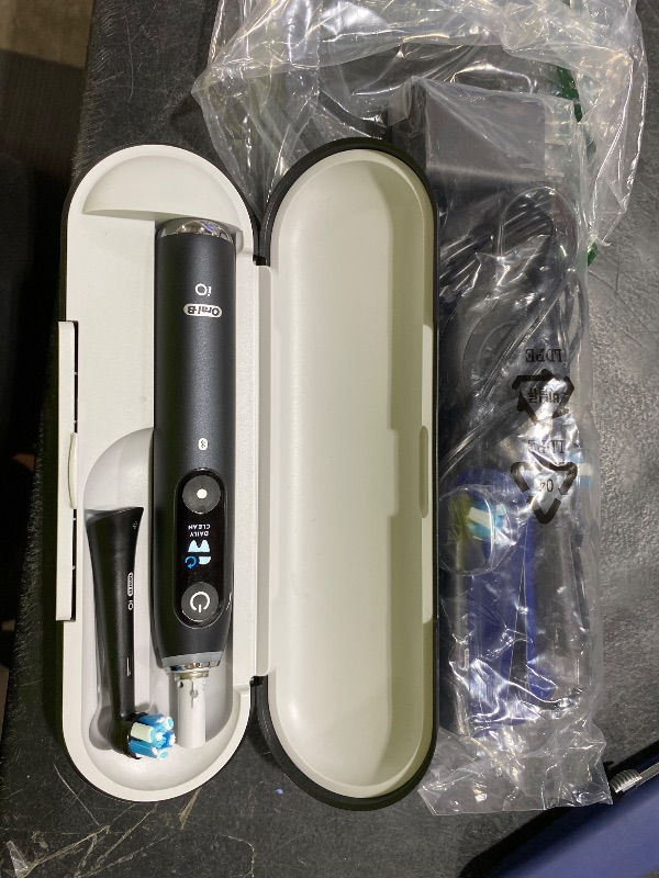 Photo 1 of Oral-B Rechargeable Electric Toothbrush, iO Series 9 Genius, Black, 4 Replacement Brush Heads, Power Charging Travel Case, Teeth Whitening, Visible Pressure Sensor to Protect Gums, 7 Modes