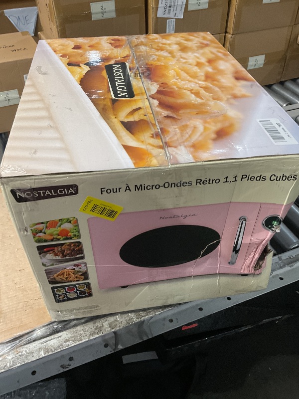 Photo 1 of **BACK IS DENTED*SOLD FOR PARTS* Nostalgia Retro 1000W Microwave Oven 1.1 Cu Ft Capacity – Child Safety Lock, 8 Auto-Cook Settings – Countertop Kitchen Appliance – Pink