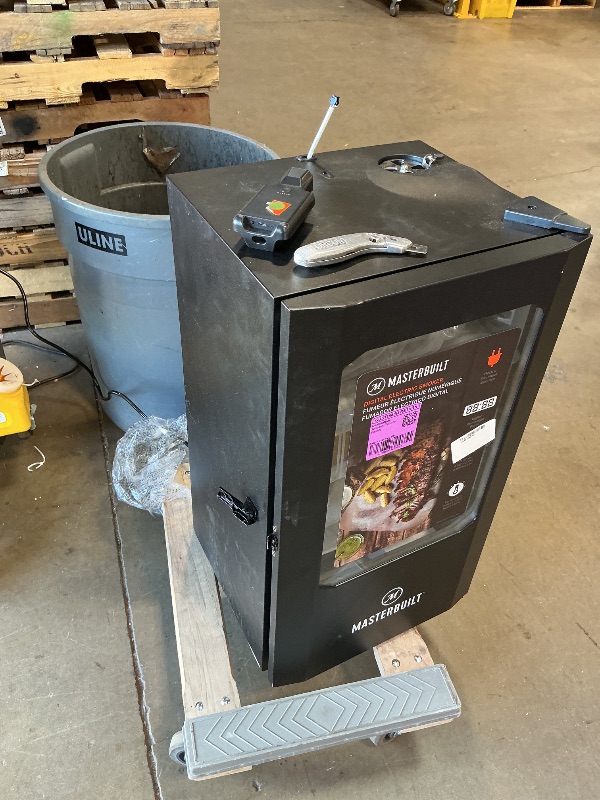 Photo 1 of ***MINOR DENT ON TOP***Masterbuilt® 30-inch Digital Electric Vertical BBQ Smoker with Leg Kit, Side Wood Chip Loader and 710 Cooking Square Inches in Black, Model MB20070421