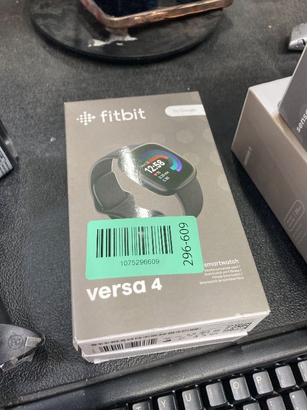 Photo 1 of **WONT CHARGE**Fitbit Versa 4 Fitness Smartwatch with Daily Readiness, GPS, 24/7 Heart Rate, 40+ Exercise Modes, Sleep Tracking and more, Waterfall Blue/Platinum, One Size (S & L Bands Included)