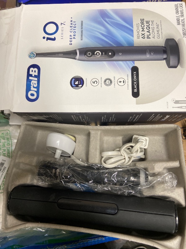 Photo 1 of **NEEDS CLEANING**Oral-B iO Deep Clean + Protect Rechargeable Electric Toothbrush, Black, iO Series 7, 2 Replacement Brush Heads, Charging Travel Case (package may vary)