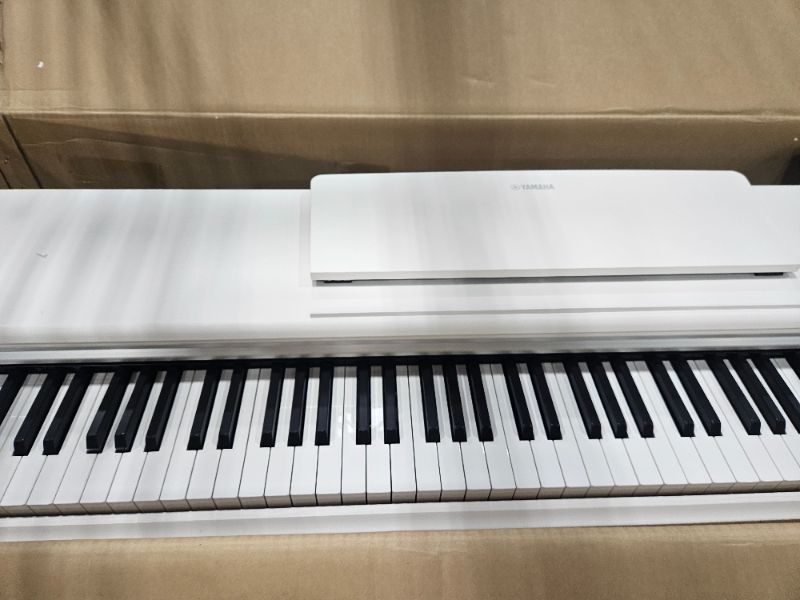 Photo 1 of ** For parts only, side panel is cracked and some keys get stuck ** Yamaha YDP105 88-Key Weighted Action Upright Digital Piano for Beginner and Intermediate Players, Dynamic Response, Grand Piano Sound, 3-pedal Unit, Upright Design, Bench Included, White