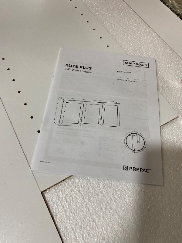 Photo 1 of Prepac Elite 54" W Wall Cabinet with Panel Doors, White Storage Cabinet, Bathroom Cabinet, Pantry with 1 Adjustable Shelf 12.75" D x 54" W x 24" H, WSUR-1004-1
