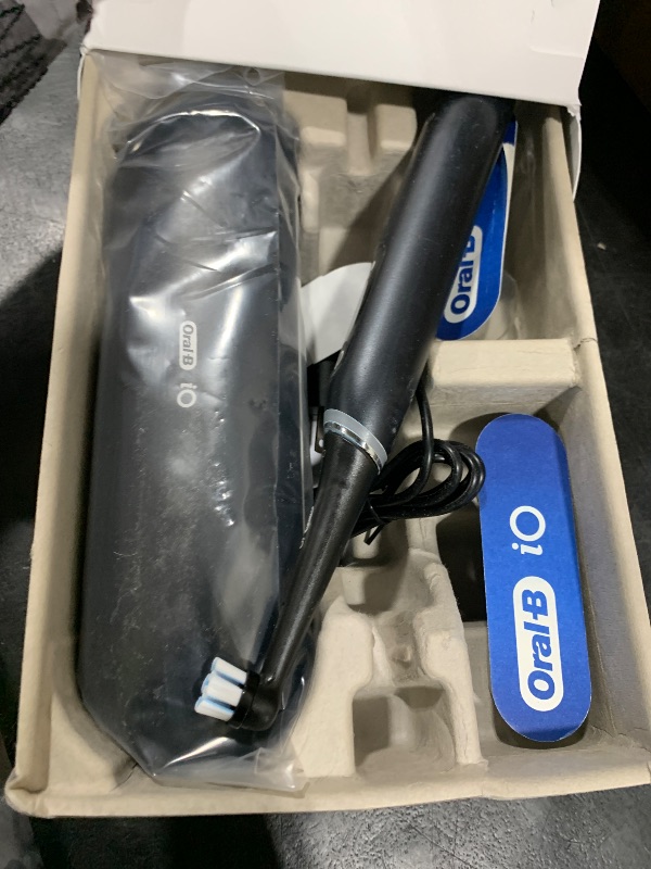 Photo 1 of Oral-B iO Deep Clean + Protect Rechargeable Electric Toothbrush, Black, iO Series 7, 2 Replacement Brush Heads, Charging Travel Case (package may vary)