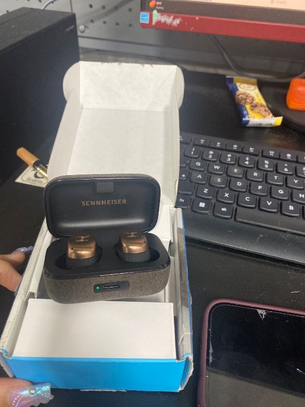 Photo 1 of SELLING FOR PARTS ONLY,,,,,,,,,,,,,,,SENNHEISERThis image shows the Sennheiser MOMENTUM True Wireless 4 earbuds in the Black Copper