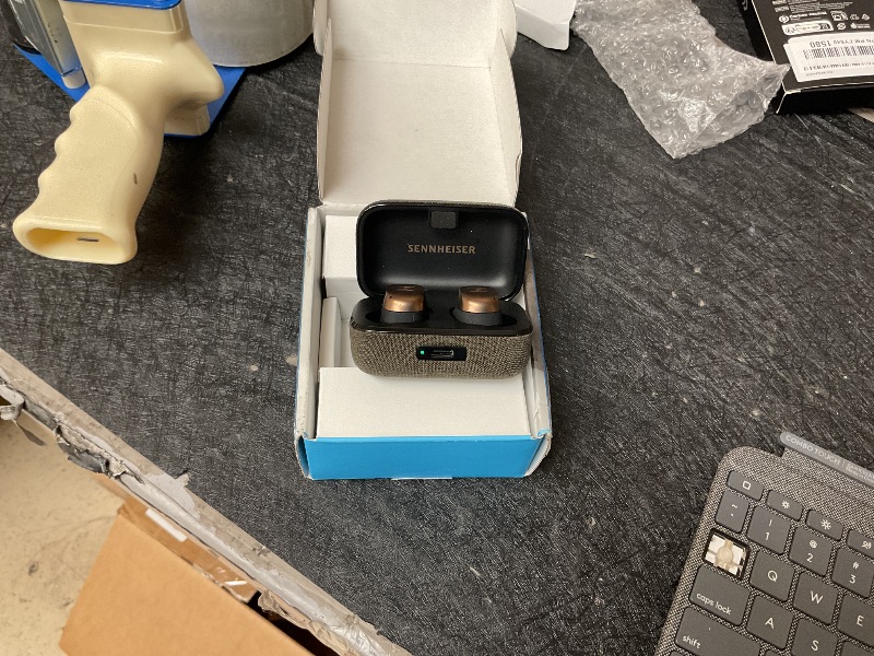 Photo 1 of SELLING FOR PARTS ONLY,,,,,,,,,,,,,,,SENNHEISERThis image shows the Sennheiser MOMENTUM True Wireless 4 earbuds in the Black Copper