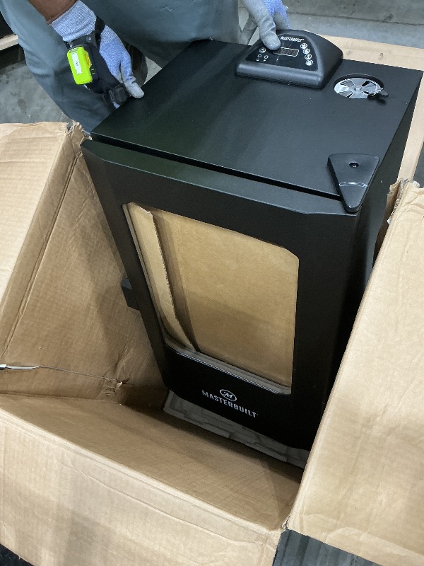 Photo 1 of **UNTESTED**
Masterbuilt® 30-inch Digital Electric Vertical BBQ Smoker with Leg Kit, Side Wood Chip Loader and 710 Cooking Square Inches in Black, Model MB20070421