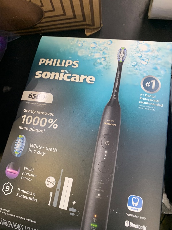 View 3 of **USED/DAMAGED** Philips Sonicare 6500 Series Electric Toothbrush - Next-Generation Sonicare Technology, Pressure Sensor, 9 Brushing Settings, SmarTimer, BrushPacer, 21-Day Runtime, Travel Case, Black, HX7411/08