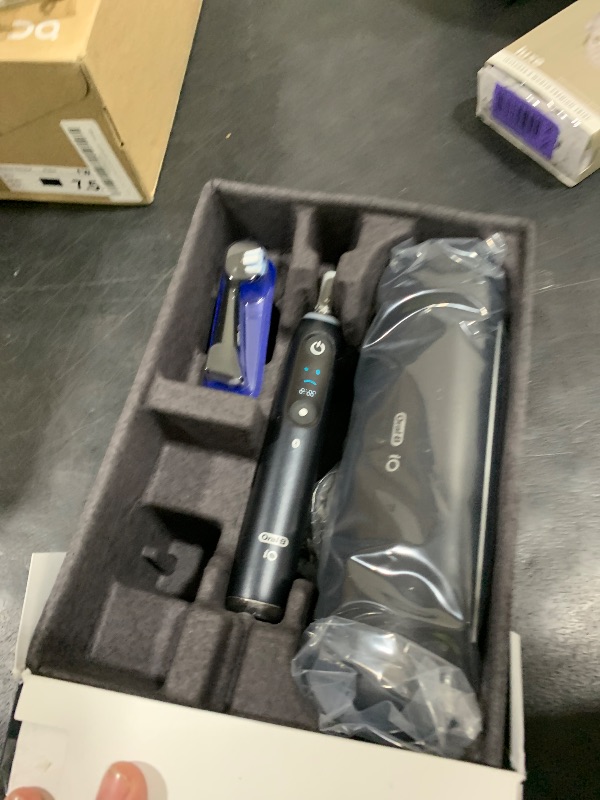 Photo 1 of Oral-B Rechargeable Electric Toothbrush, iO9 Limited Ultimate Clean, 7 Cleaning Modes, Interactive Display, iSense Charger, Charging Travel Case, Visible Pressure Sensor, 3 Brush Heads, Black