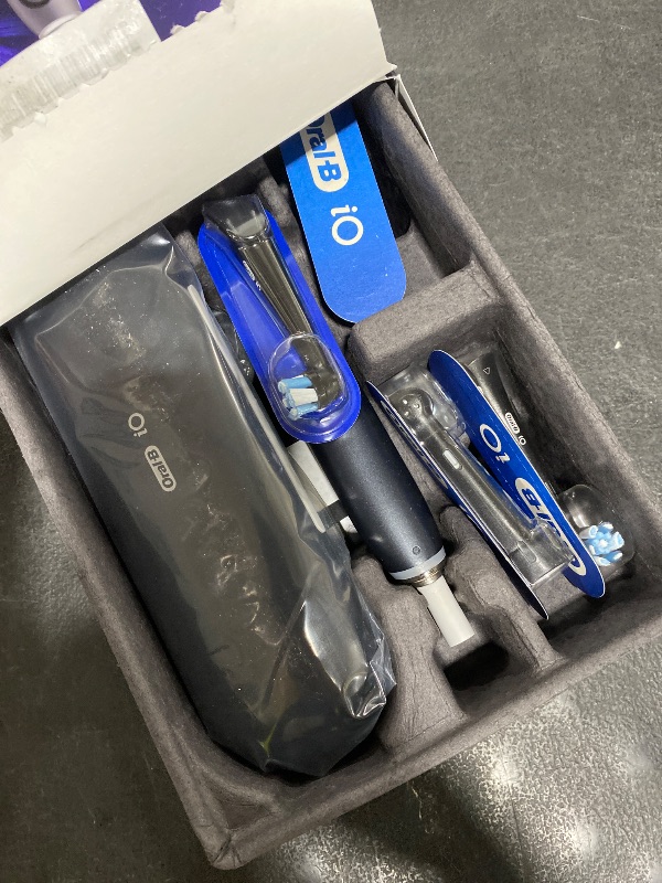 Photo 1 of Oral-B Rechargeable Electric Toothbrush, iO Series 9 Genius, Black, 4 Replacement Brush Heads, Power Charging Travel Case, Teeth Whitening, Visible Pressure Sensor to Protect Gums, 7 Modes