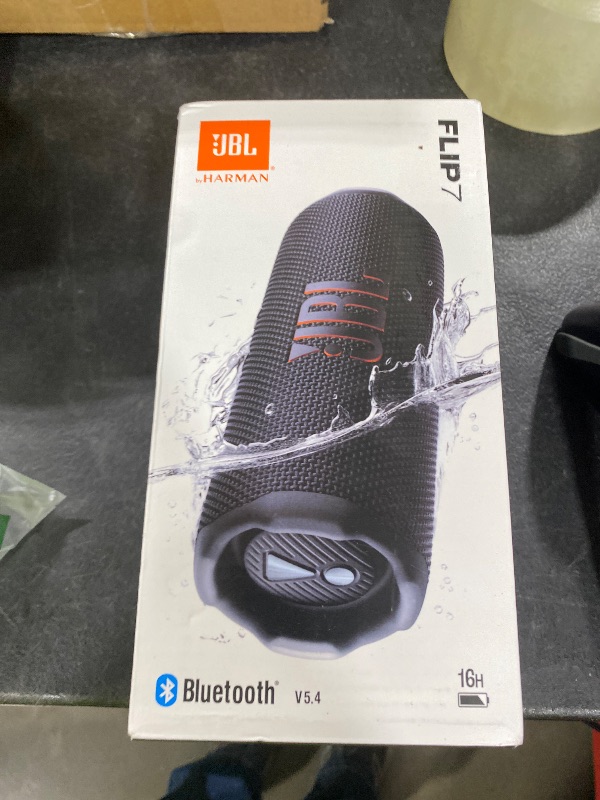 Photo 1 of JBL Flip 7 - Portable Waterproof and Drop-Proof Speaker, Bold JBL Pro Sound with AI Boost, 16Hrs of Playtime, and PushLock System with Interchangeable Accessories (Black)
