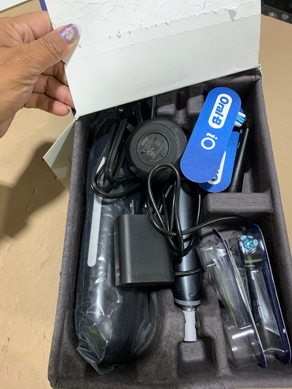 Photo 1 of Oral-B Rechargeable Electric Toothbrush, iO Series 9 Genius, Black, 4 Replacement Brush Heads, Power Charging Travel Case, Teeth Whitening, Visible Pressure Sensor to Protect Gums, 7 Modes