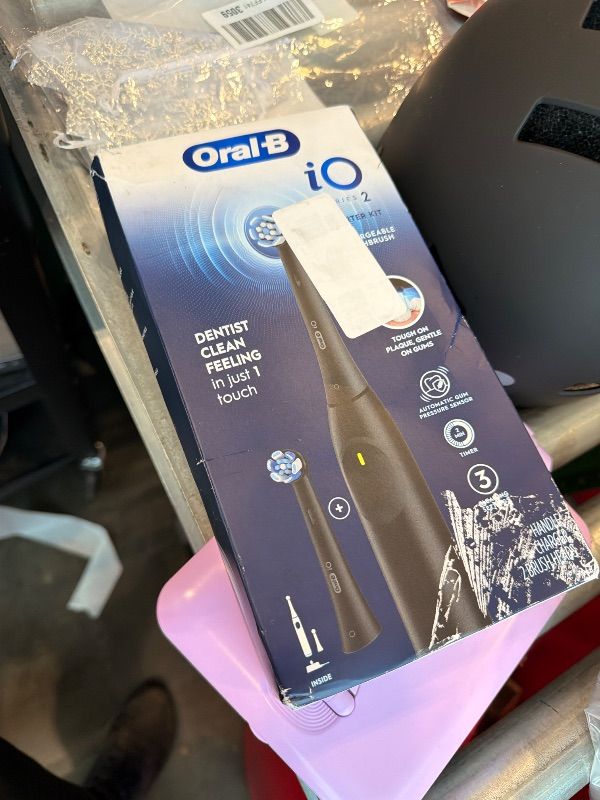 Photo 1 of [Doesn't Charge] Oral-B Rechargeable Electric Toothbrush, iO2 Starter Kit, 3 Cleaning Modes, Automatic Pressure Sensor to Protect Gums, 2 Brush Heads, Night Black