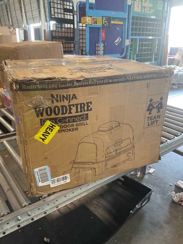 Photo 1 of [HEAVILY USED] [ MISSING MAIN FOOD TRAY] [DAMAGED/ILLEGIBLE CONTROLS] Ninja Woodfire Pro Connect XL Outdoor Grill & Smoker | Bluetooth, App Enabled | 7-in-1 Grill, BBQ Smoker, Outdoor Air Fryer | Woodfire Technology | Built-In Thermometer | Blue & Gold| O