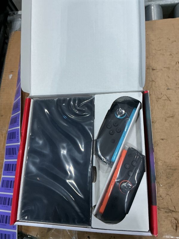Photo 1 of **AS IS,FINAL SALE** Nintendo Switch with Neon Blue and Red Joy-Con (Renewed)