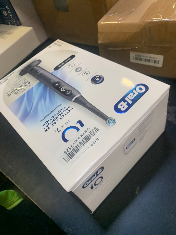 Photo 1 of Oral-B iO Deep Clean + Protect Rechargeable Electric Toothbrush, Black, iO Series 7, 2 Replacement Brush Heads, Charging Travel Case (package may vary)