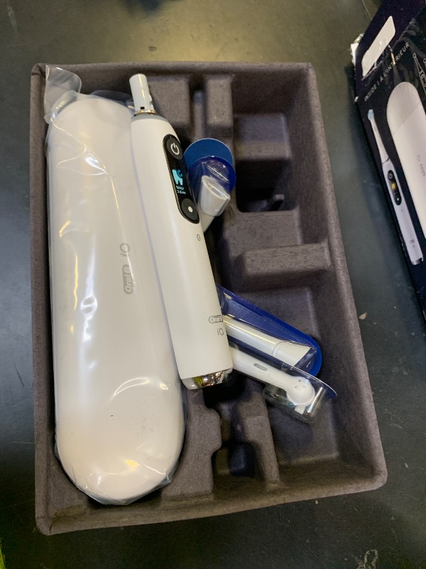 Photo 1 of Oral-B Rechargeable Electric Toothbrush, iO9 Genius, 7 Cleaning Modes, Interactive Display, Charging Travel Case, Visible Pressure Sensor, 4 Brush Heads, White Alabaster