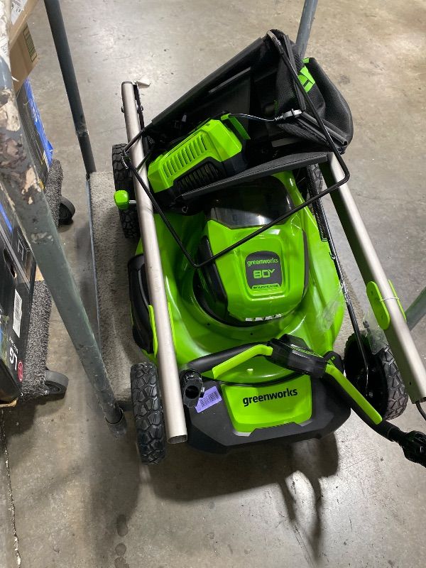 Photo 1 of ONLY LAWNMOWER, NO OTHER ACCSESORIES*******INCOMPLETE, NO BOX** Greenworks 48V (24V x 2) 21" Brushless Self-Propelled Mower+12" String Trimmer+320CFM Blower,(2) 5.0Ah Batteries and 4A Dual Port Charger