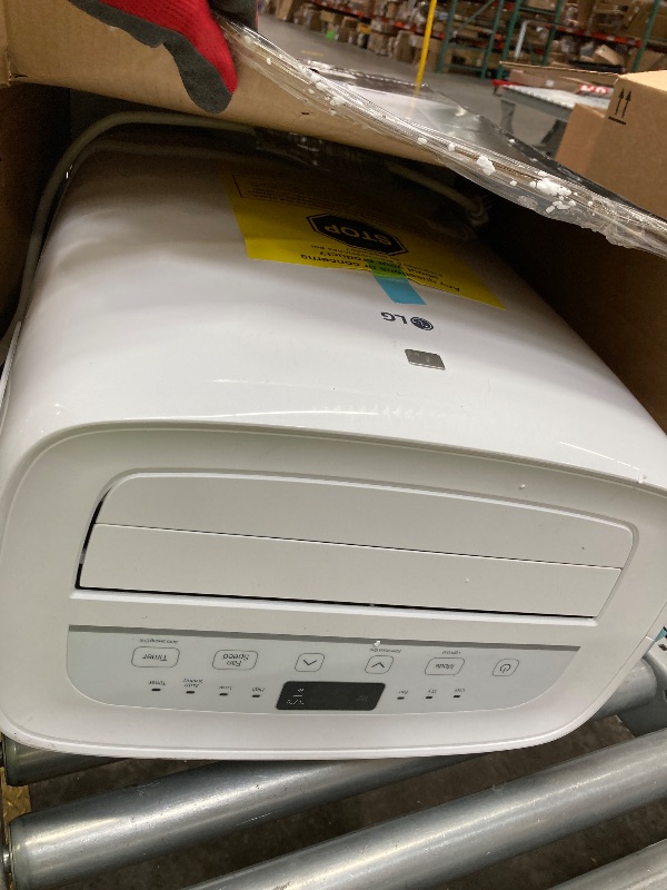 Photo 1 of ***The unit is missing a wheel and cannot stand properly and is leaking water from the bottom.***LG 7,000 BTU (DOE) 10,000 BTU (ASHRAE) Portable Air Conditioner, 115V, Cools 300 Sq.Ft. (12' x 25' Room Size), Quiet Operation, LCD Remote Control, and Window