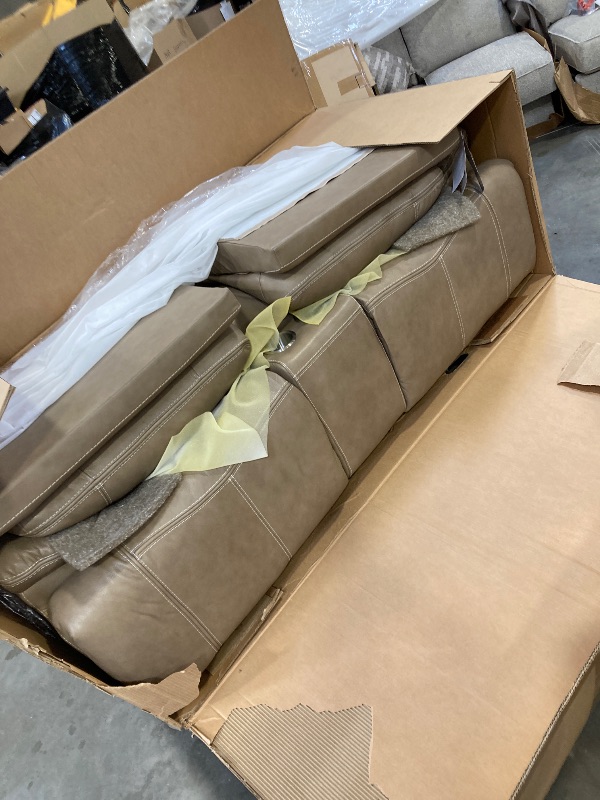 Photo 1 of Signature Design by Ashley Ricmen Leather Adjustable Dual Sided Power Reclining Loveseat with USB Charging & Console, Light Brown----PLEASE BRING TRUCK UPON PICK UP ITEM IS XL -------FACTORY SEALED 
