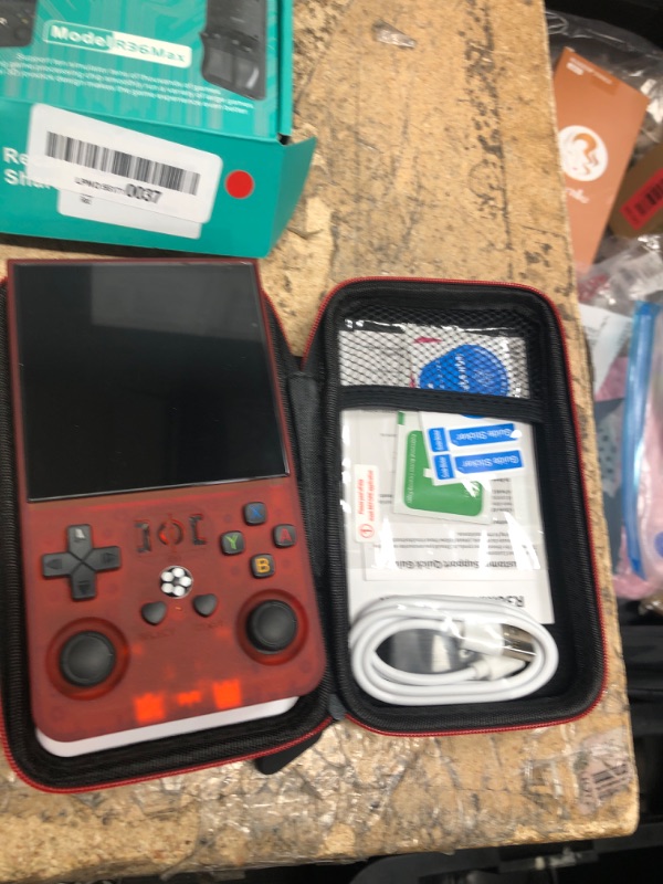 Photo 1 of *WON'T TURN ON* R36MAX Retro Handheld Games Console, Retro Game Console with 4.0 inch IPS HD Screen, Video Game Consoles with 64GB Memory, Portable Gaming Player for Travel, Gift for Teen or Partner, Transparent Red