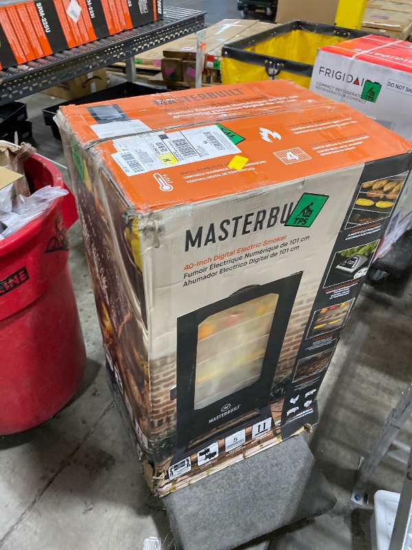 Photo 1 of Masterbuilt® 40-inch Digital Electric Vertical BBQ Smoker with Leg Kit, Side Wood Chip Loader and 970 Cooking Square Inches in Black, Model MB20070122